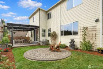 Wonderful backyard with covered patio, open patio and lovely flower beds.