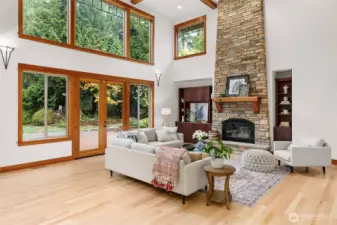 Great Room with double height box beam ceiling and expansive windows