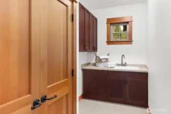 Laundry room featuring storage closet and utility sink; washer and dryer connections available