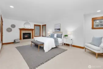 The generously sized upstairs Primary bedroom features a propane fireplace and en-suite bathroom