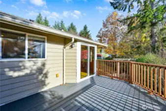 The top-level, weather-resistant deck is just off of the dining area by the sliding glass door.