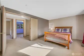 To the left of the landing is the primary bedroom, with French doors, built-in cubbies, two closets, a personal sink, and a private water closet with a shower.  Plus a big west-facing window provides views of the sunsets.