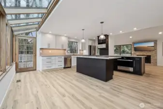 Kitchen looking from wall of windows to back deck