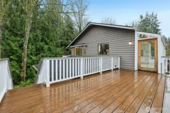 Main floor deck off kitchen with steps leading to the yard