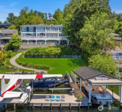 Lakefront Living at It's Finest! Privacy combined with expansive lawn and deck for living and entertaining while enjoying West Cost sunshine and sunsets.