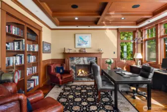 Fabulous office with sliding bookshelves to an additional private room with windows and a fireplace of it's own.