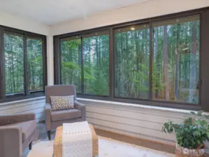 Private personal sunroom located in primary suite bathroom, fully enclosed and overlooking back yard with greenbelt.