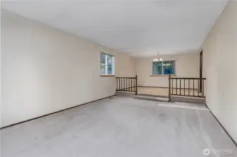 Carpeted family room leading to dining area.