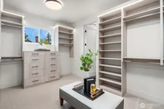 The Primary Bedroom closet is a masterfully designed space, featuring custom-built shelves and drawers for optimal organization. A charming clerestory window lets in an abundance of natural light, creating a bright and inviting atmosphere.