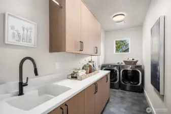 The spacious 2nd-floor laundry room is equipped with LG washer and dryer, complemented by generous granite countertops perfect for folding laundry. Featuring elegant Belmont cabinets and a dedicated sink for hand-wash items, this room is both functional and stylish. Conveniently accessible through either the Primary Closet or the hallway, it offers ultimate ease and practicality.