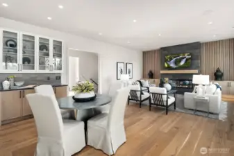 Another view from the kitchen to the dining area and great room. Featuring the beverage station with built in display shelves above.