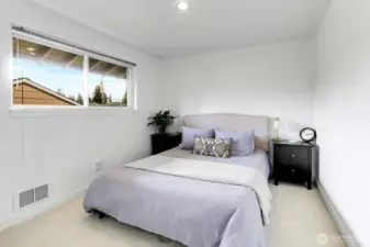 The primary bedroom is light-filled and cozy.