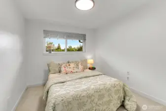 Comfortable and spacious bedroom features ample natural light and space to unwind.