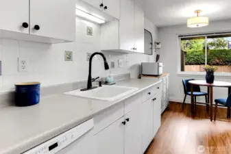 Crisp, clean, and functional, the kitchen features generous counter space and updated fixtures.