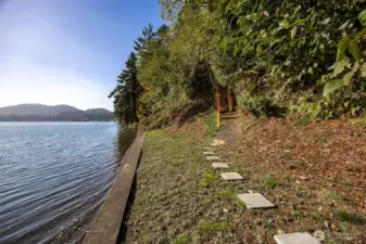 A view down eld inlet from the builkhead shows a photo of the medium high bank and stairs leading up to the path to the home.