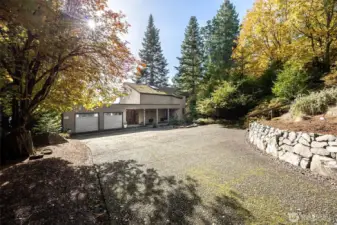 The gentle slopping access to this stunning home passes the upper terrace with a 5 bay parking garage and curves down to the two car garage and provides easy turnaround space embraced by lovely landscaping.