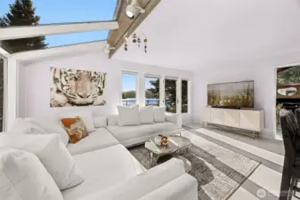 The extended living space next to the kitchen also features front water views, deck access and offers a large wall for the big screen or spacial art piece.  Bask in the winter or summer light and watch the cook create.