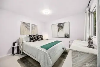 Off the front hall way this comfortable space can serve as a main floor bedroom or office with view of the front garden space.  An ample closet sits to the right of the photo.