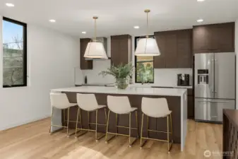 Oversized kitchen island with quartz waterfall