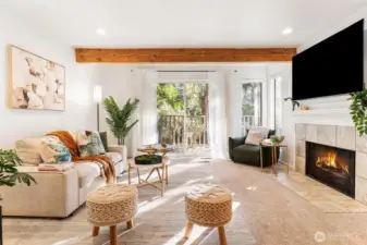 Living room thoughtfully designed to maximize space, natural light and wood fireplace