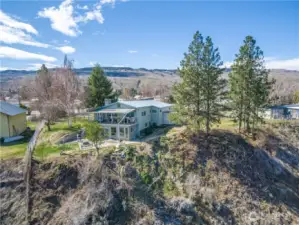 Back side of the house looking from north to south...sunroom on lower level and deck above on main level.
