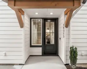 Covered front entry with modern farmhouse design and welcoming curb appeal.