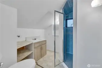 Upstairs bathroom with tile shower.