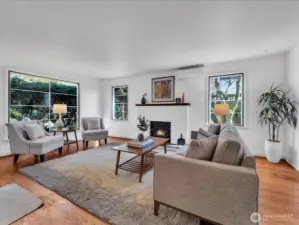 Open Living room with wood burning fireplace.