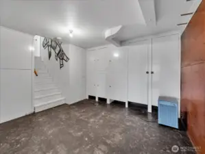 Landing area at the bottom of the stairs with amazing storage.