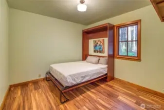 Murphy bed in one of two main floor bedrooms allows for flexible use of space.