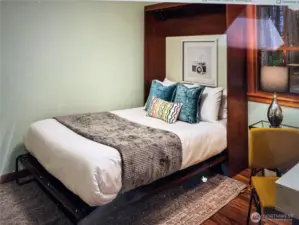 Murphy bed in one of two main floor bedrooms allows for flexible use of space.