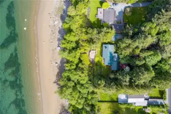 Expansive 154± feet of waterfront with lush greenery and direct beach access—an incredible island investment.