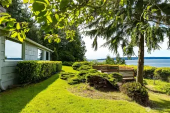 Sprawling lawn and lush landscaping lead to panoramic water views—nature and privacy in perfect harmony.