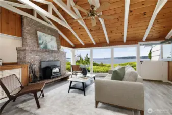 Gather around the brick hearth while gazing out expansive windows overlooking Baby Island and Puget Sound.