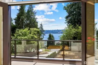 Seamless indoor-outdoor living with French doors leading from both the living and dining areas to the vast southwest-facing view deck
