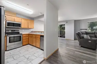 Kitchen with stainless appliances, brand new microwave and new tile floors.