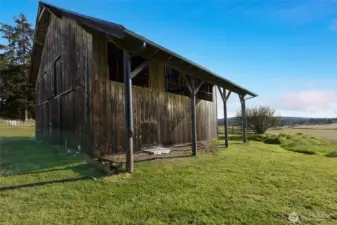 A FABULOUS two story barn with a hay bail conveyor, concrete floors, lots of possibilities. Farm animals or convert it into a party barn! Newer metal roof.