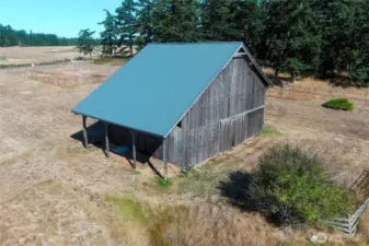 A FABULOUS two story barn with a hay bail conveyor, concrete floors, lots of possibilities. Farm animals or convert it into a party barn! Newer metal roof.