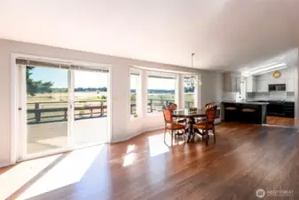 Living room with a large sliding door to the deck. Dining area and open kitchen with Stainless Steel refer. Easy maintenance flooring.