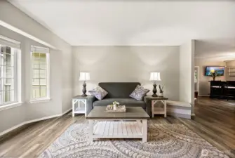 Bay windows flood the living room with natural light.