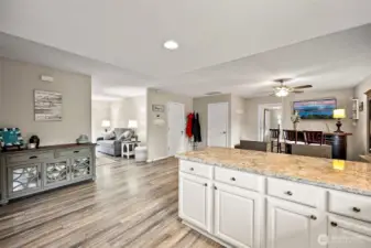 Designer paint, modern laminate flooring, and updated kitchen with granite - this is a great space.  A large dining table would easily fit in this dining room.