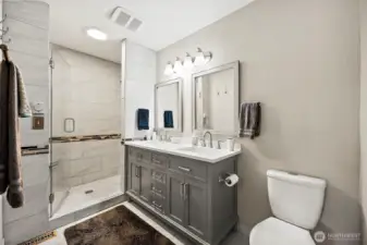 Dual vanity and custom tile shower.