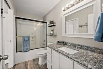 Main full bath with granite countertop.