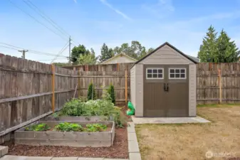 Raised garden beds are ready to go!  Store your garden tools in the garden shed. Outbuilding