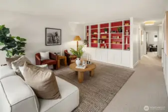 Large living space with custom built-in cabinetry and shelving.