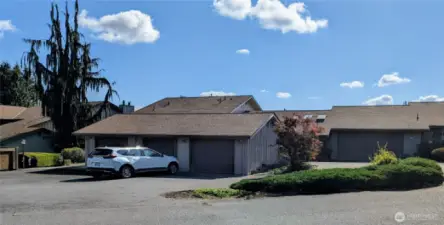 Unit B, to the right of the white car.