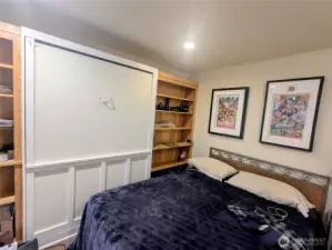 Second bedroom with murphy bed and built-in bookcases.  This stays with the condo.