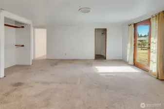 Primary bedroom with ensuite bathroom and direct access to the back yard
