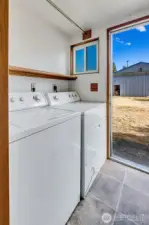 Laundry/mud room with direct access to the back yard and garden beds.