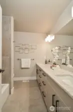 Upper level bathroom with double vanity.